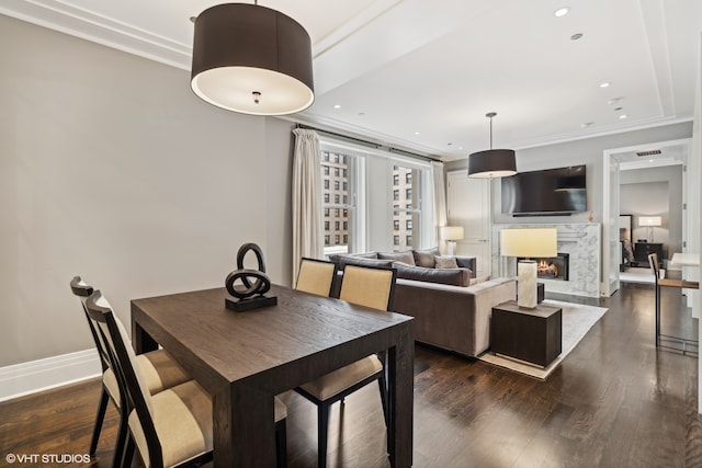 dining room with crown molding and dark wood-type flooring