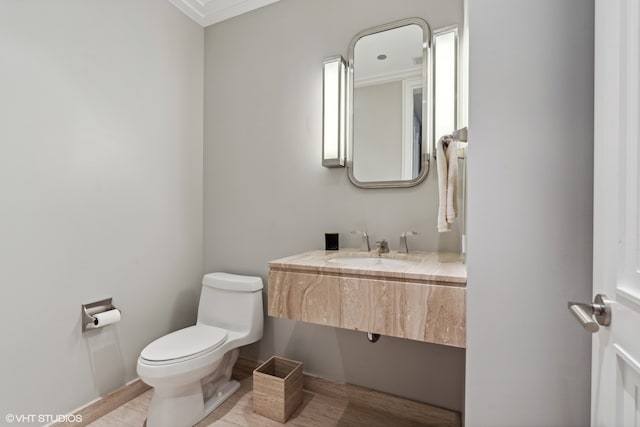 bathroom with sink, hardwood / wood-style flooring, and toilet