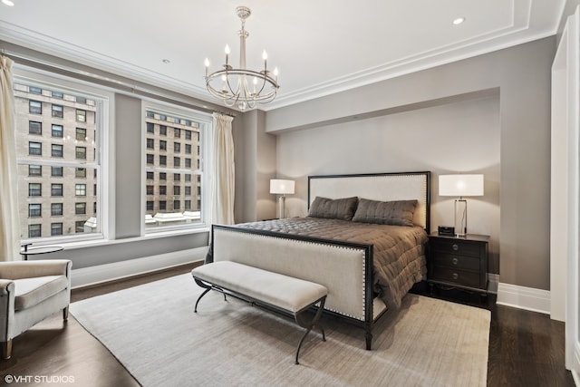 bedroom featuring a chandelier, ornamental molding, and dark hardwood / wood-style flooring