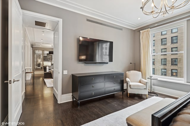 sitting room with a healthy amount of sunlight, dark hardwood / wood-style floors, and a chandelier