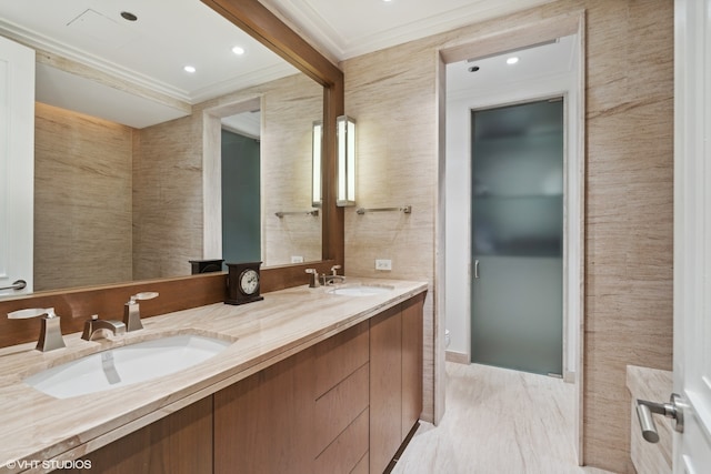 bathroom with tile walls, crown molding, double vanity, and tile flooring