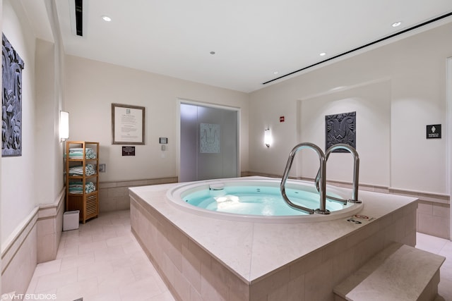 interior space with a hot tub and light tile floors