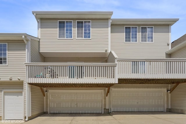 33 S Treehouse Ln, Round Lake, IL 60073 - rear view of house with a balcony, an attached garage, and driveway