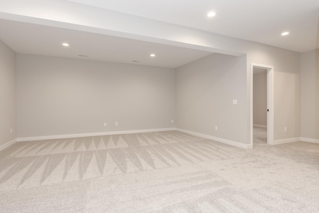 unfurnished room featuring light carpet