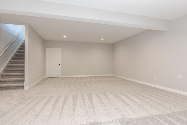 interior space with beam ceiling and light colored carpet