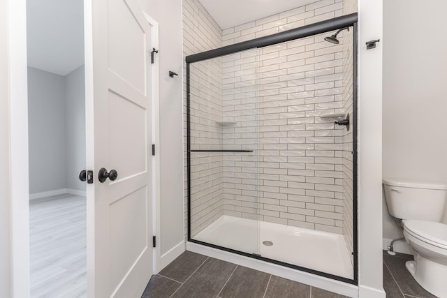 bathroom with toilet and walk in shower