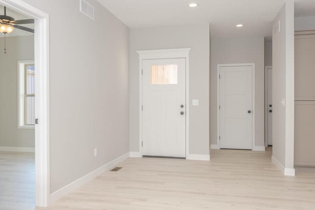 foyer with ceiling fan and light hardwood / wood-style flooring