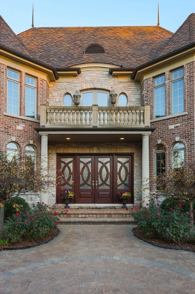 doorway to property with a balcony and french doors