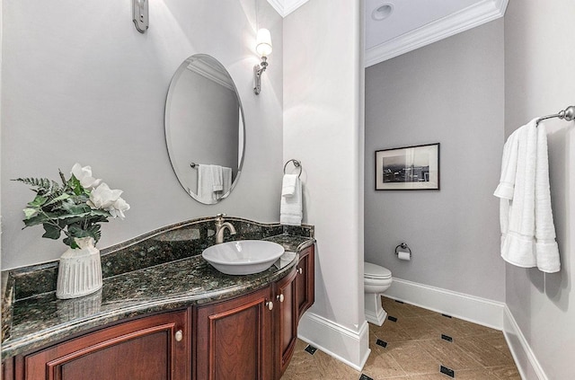 bathroom with crown molding, vanity, and toilet