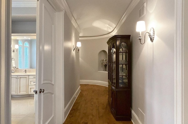 corridor featuring crown molding and dark wood-type flooring