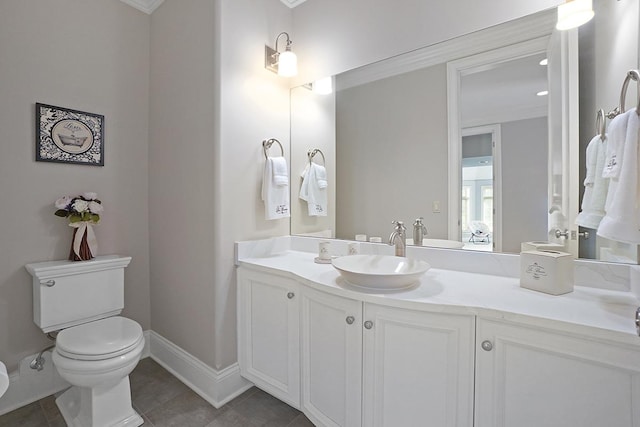 bathroom featuring tile patterned flooring, vanity, toilet, and crown molding