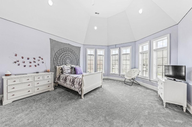 carpeted bedroom with high vaulted ceiling