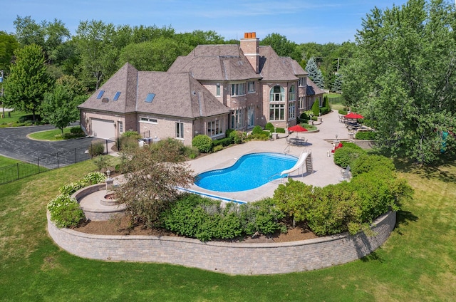 view of pool with a lawn and a patio