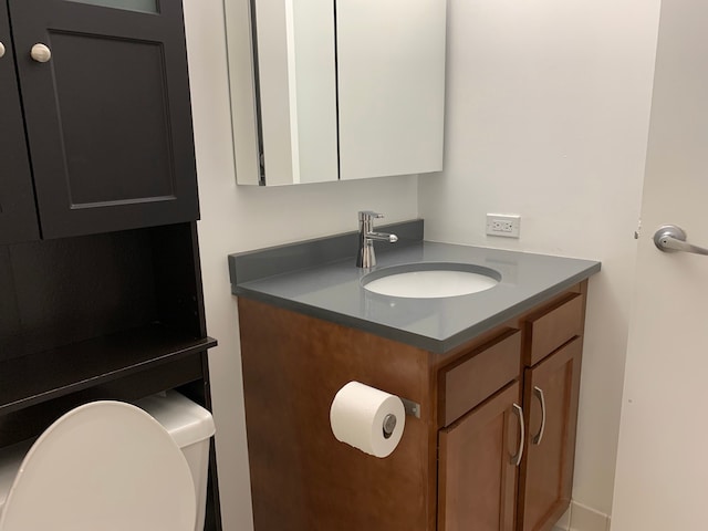 bathroom featuring toilet and vanity