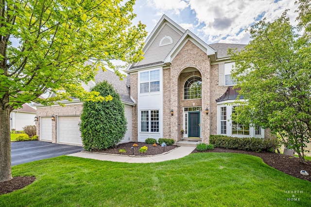 730 Fenview Cir, Algonquin, IL 60102 - traditional home with driveway, brick siding, a front lawn, and a garage