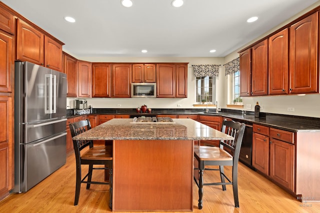 730 Fenview Cir, Algonquin, IL 60102 - kitchen featuring stainless steel appliances, a breakfast bar, light wood-type flooring, dark stone countertops, and recessed lighting