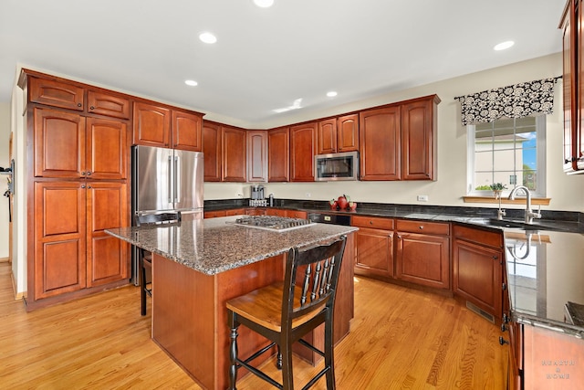730 Fenview Cir, Algonquin, IL 60102 - kitchen with appliances with stainless steel finishes, a kitchen bar, light wood-style floors, recessed lighting, and dark stone countertops