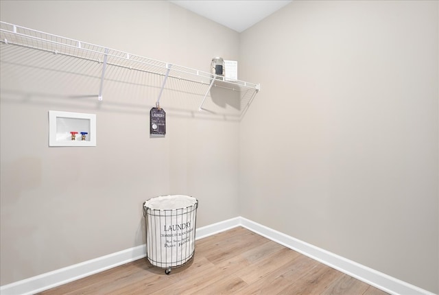 washroom with hookup for a washing machine and light hardwood / wood-style floors