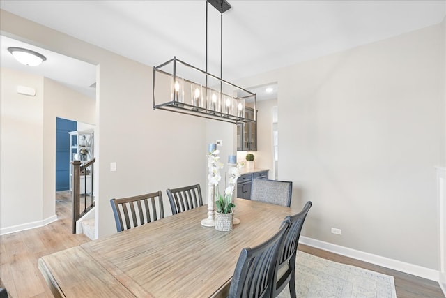 dining area featuring an inviting chandelier and light hardwood / wood-style floors