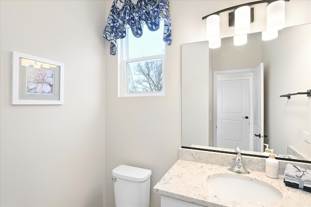 bathroom featuring toilet and vanity