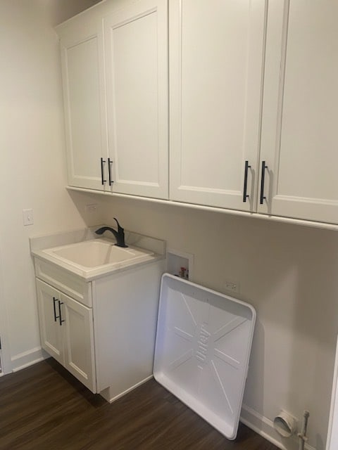 laundry area with washer hookup, dark hardwood / wood-style flooring, cabinets, and sink