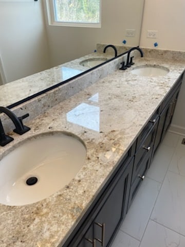 bathroom featuring double sink vanity and tile floors