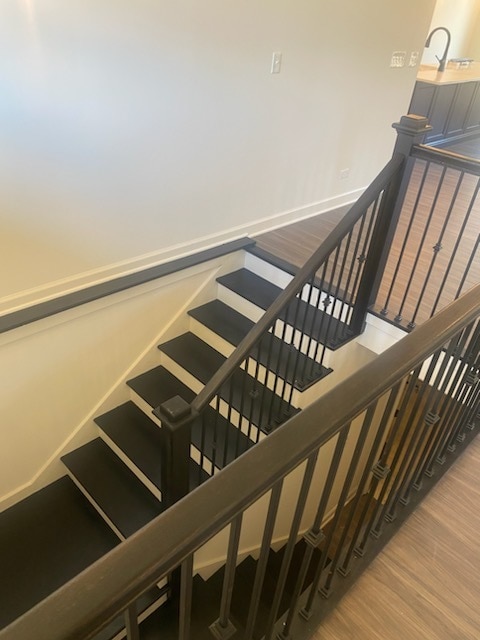 stairway featuring hardwood / wood-style floors