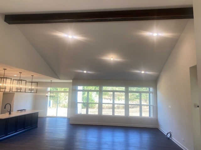 interior space with beamed ceiling, dark hardwood / wood-style floors, a notable chandelier, high vaulted ceiling, and sink