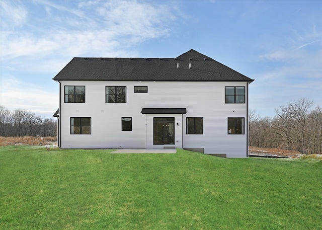 rear view of house featuring a patio area and a yard