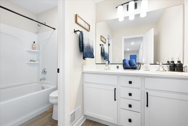 full bathroom featuring hardwood / wood-style flooring, toilet, double vanity, and bathing tub / shower combination