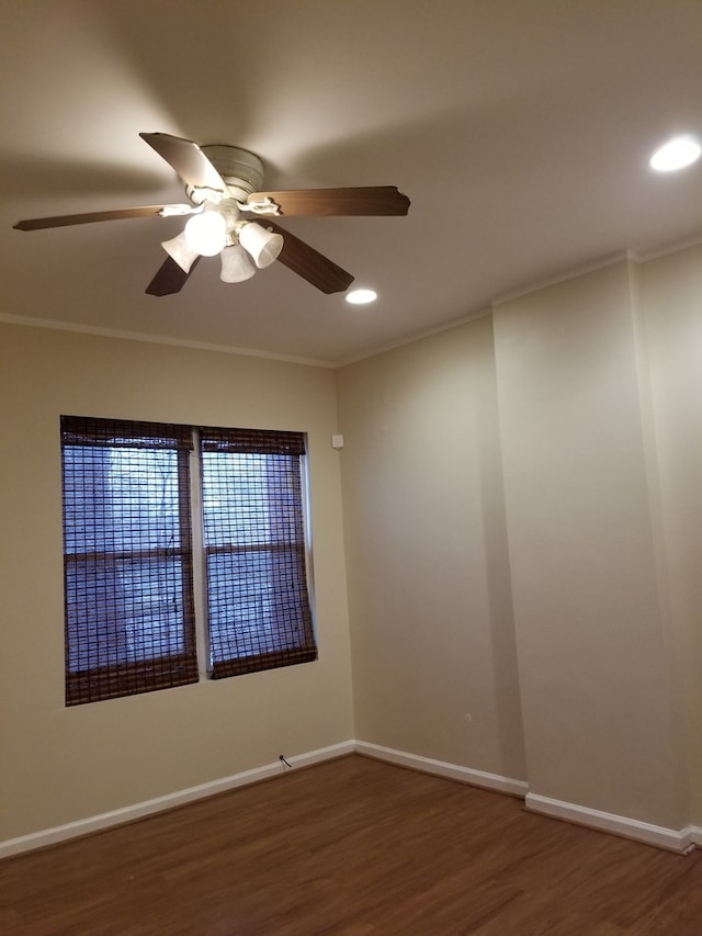 unfurnished room with crown molding, dark hardwood / wood-style floors, and ceiling fan