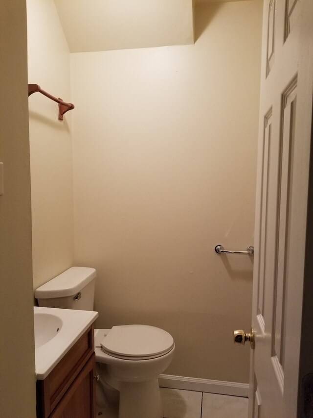 bathroom featuring tile floors, toilet, and vanity