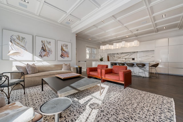 living room featuring coffered ceiling and dark hardwood / wood-style floors