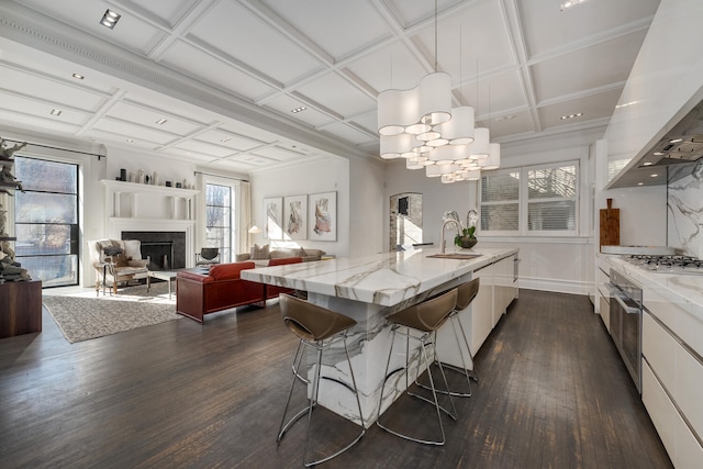 kitchen featuring white cabinets, coffered ceiling, and dark hardwood / wood-style floors