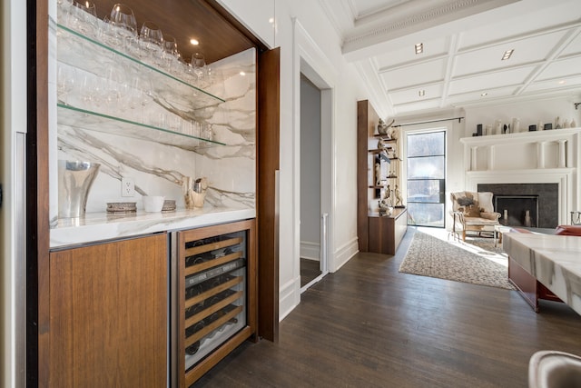 bar with coffered ceiling, wine cooler, light stone countertops, and dark hardwood / wood-style flooring