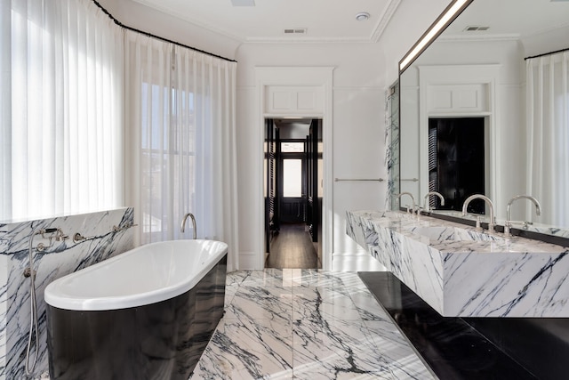 bathroom featuring a washtub, vanity, crown molding, tile walls, and tile flooring