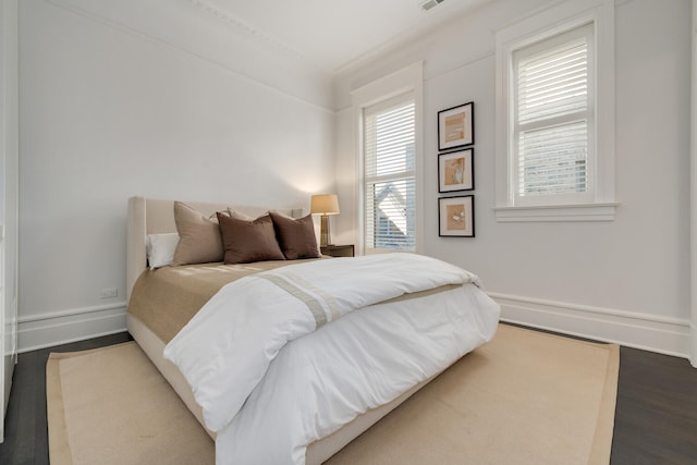 bedroom with dark wood-type flooring