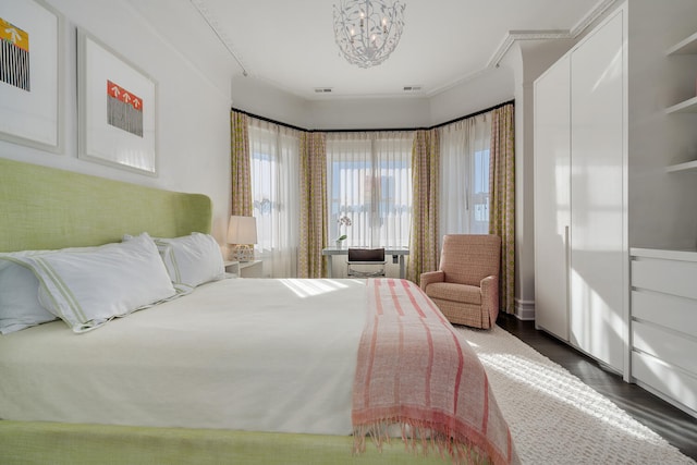 bedroom with ornamental molding and dark wood-type flooring