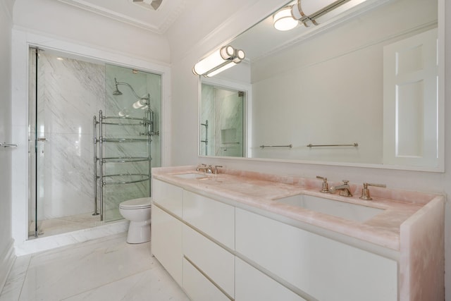 bathroom featuring toilet, double sink vanity, ornamental molding, a shower with shower door, and tile flooring