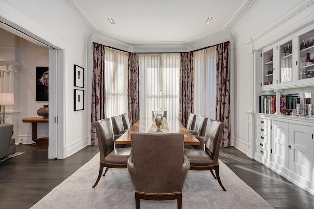 dining space featuring dark hardwood / wood-style flooring and ornamental molding