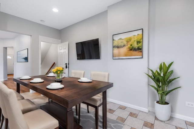 dining area featuring light tile flooring