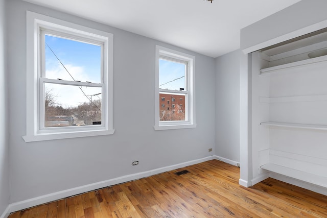 unfurnished room with light wood-type flooring