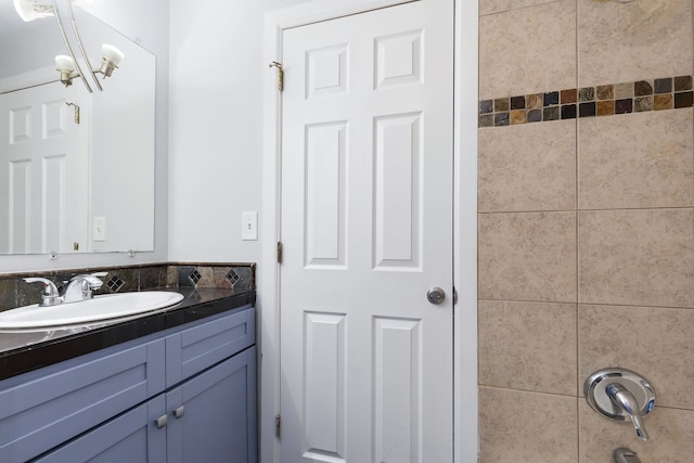 bathroom featuring an inviting chandelier and vanity