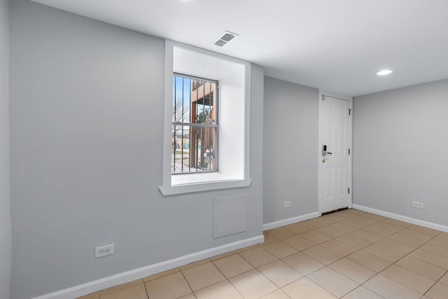 spare room featuring light tile floors