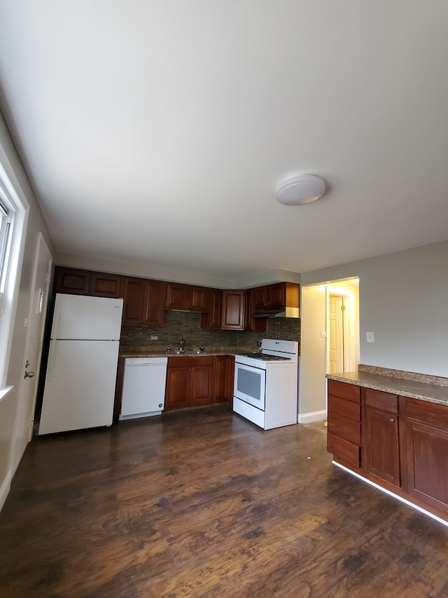 kitchen featuring white appliances, tasteful backsplash, dark wood-type flooring, and sink