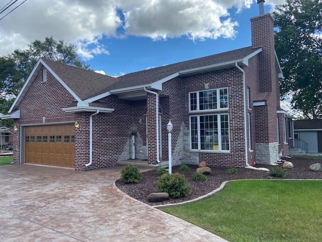 view of front of house with a front yard and a garage