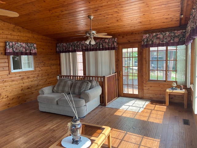 unfurnished living room featuring vaulted ceiling, wooden ceiling, light hardwood / wood-style floors, and ceiling fan