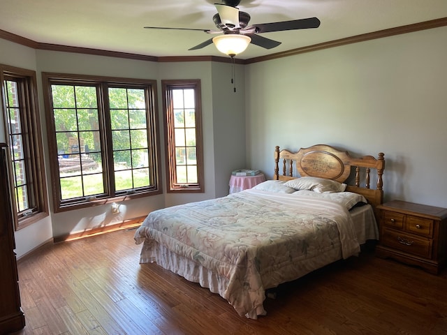 bedroom featuring ornamental molding, ceiling fan, and dark hardwood / wood-style floors