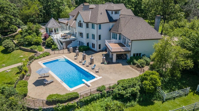 view of pool featuring a patio, a gazebo, and a diving board