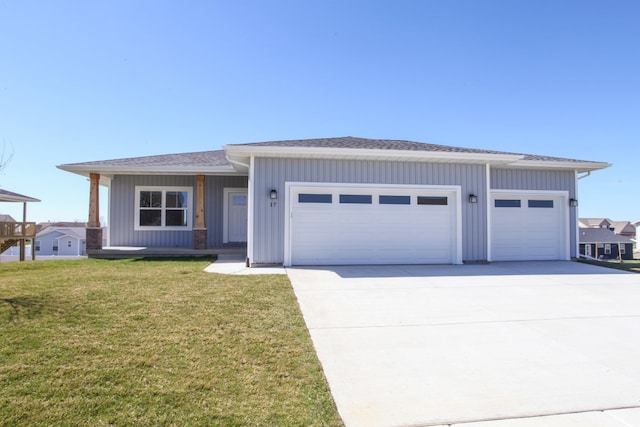 view of front of home with a front lawn and a garage